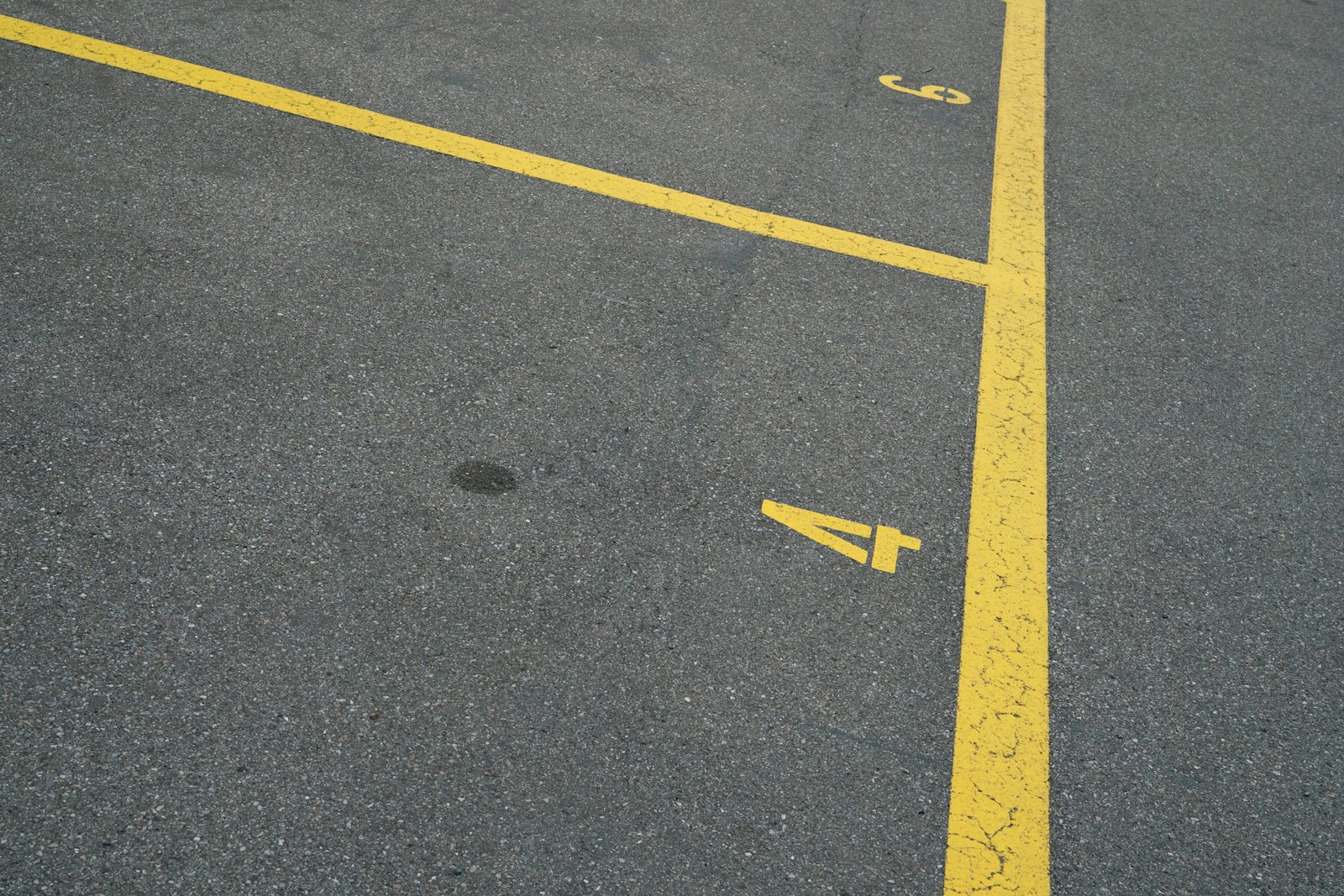 Yellow painted lines on asphalt